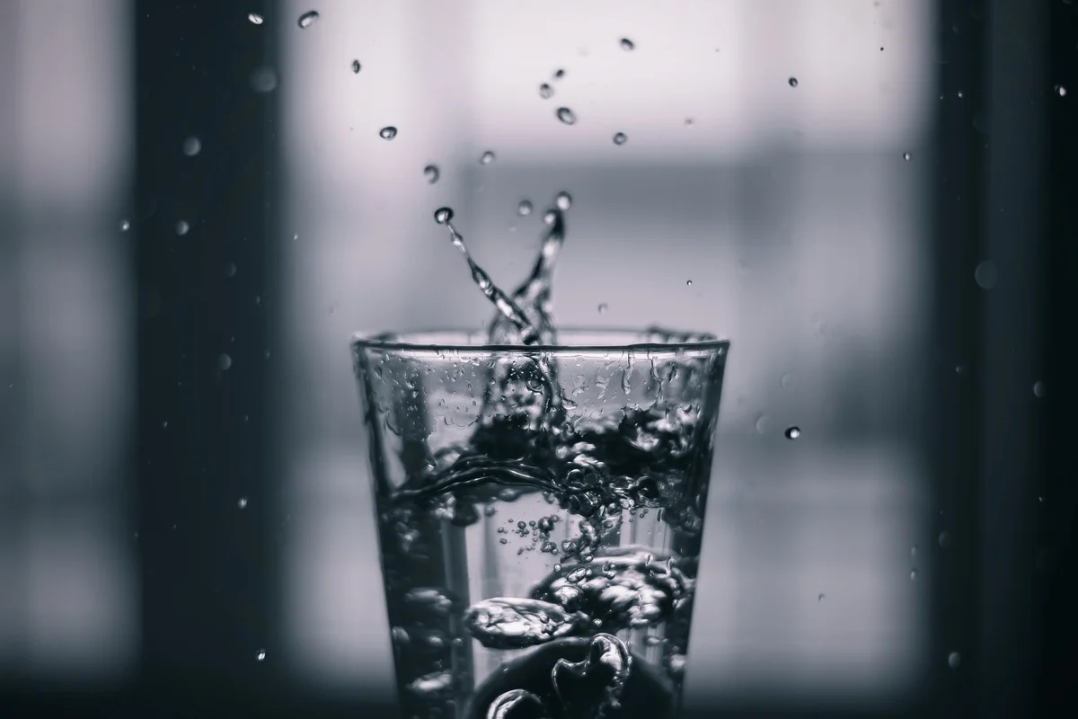 Glass of Water on Desk – Post-Extraction Hydration